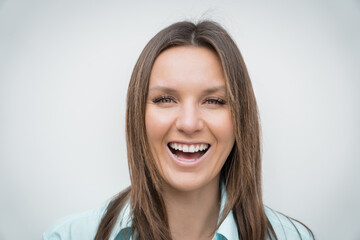 Close up portrait of young cheerful happy smiling business woman with white perfect smile looking at the camera. Positive concept