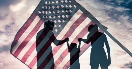 Patriotic man, woman, and child waving American flags in the air.