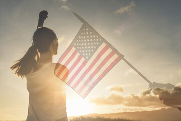 Wall Mural - Strong  patriotic woman flying the American flag. We can do it concept. 