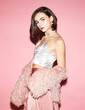 © Sergey Chumakov - young brunette woman in pink clothing isolated on pink background