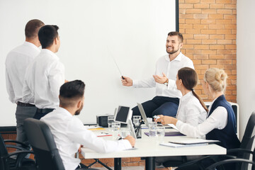 businessman giving presentation during meeting in office