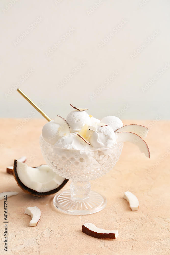 Bowl with tasty coconut ice cream on color background