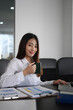 © Prathankarnpap - Portrait of attractive businesswoman holding a cup of coffee and smiling to camera.