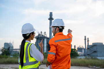 Aufkleber - Refinery industry engineer with blueprint are discussing plan work at front refinery industry.