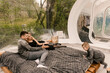 © ksyusha_yanovich - Beautiful young family man woman and son relax in the forest in nature in a large round tent with a bed and a stove for cooking, picnic, camping