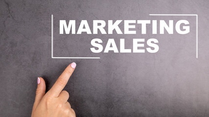 Wall Mural - MARKETING SALES concept. Woman's finger points to the text