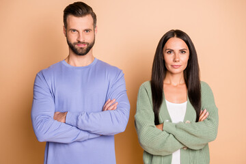 Poster - Portrait of optimistic couple arms crossed wear cardigan sweater isolated on beige color background