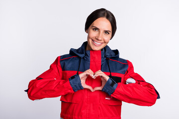 Poster - Photo of good mood young lady paramedic dressed red uniform smiling showing fingers heart isolated white color background