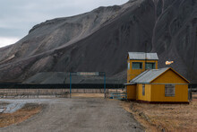 Ruined Building With Mountain In The Background In The Ghost Town Of Pyramiden, Svalbard