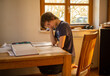© Jesus - A teenaged boy in  isolation studies at home during the corona virus pandemic