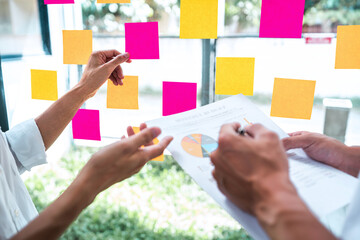 Poster - Young creative team professional using post it notes in glass wall to writing strategy business plan to development grow to success