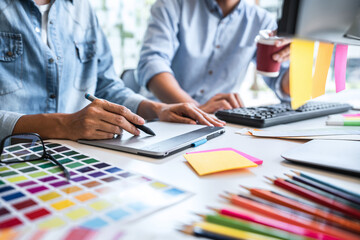 Poster - Young colleagues designers working together on a creative project and color samples for selection, Color swatch samples, Brainstorming Planning Partnership, creative graphic design working desktop