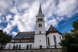 Fototapeta  - Church with a grey patterned roof in Bled.