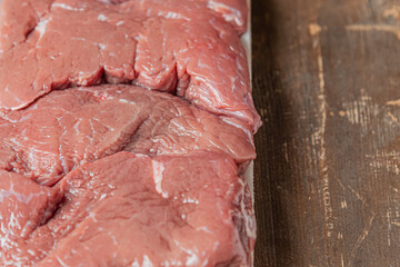 Wall Mural - packaging of raw meat on a wooden table close up