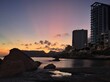 Apartment tower on quiet and beach at sunset.