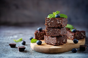 Wall Mural - Dark chocolate oats millet porridge brownies decorated with blueberries and mint leaves
