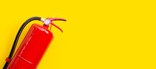 Fire Extinguisher On Yellow Background.