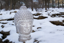 Buddha Stone Head Statue On Nature With Melting Snow Meditating Practice Yoga Mindfulness Calm Concept