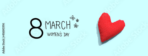 Happy womens day message with a red heart cushion - flat lay © Tierney