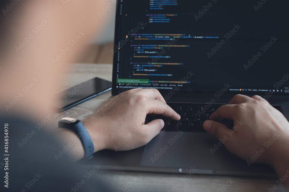 Software engineer, application developer coding javascript on laptop ...