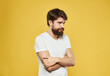 © SHOTPRIME STUDIO - Portrait of a man in a white t-shirt cropped view yellow background puzzled look model