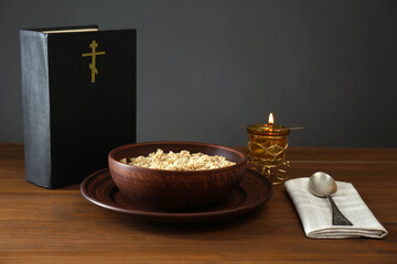 Wall Mural - Bible, oatmeal porridge and spoon on wooden table. Lent season