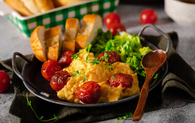 Wall Mural - Scrambled eggs with salad and grilled tomatoes