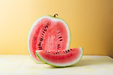 Wall Mural - Ripe watermelon  against gold background