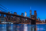 Fototapeta  - New York City Panoramic landscape view of Manhattan with famous Brooklyn Bridge at dusk .