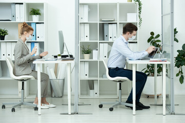 Poster - Young businessman in protective mask and formalwear wiping laptop display