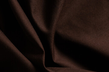 Wall Mural - dark brown wrinkled fabric as background close-up