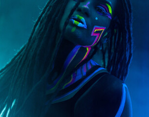 Cocky Girl with Dreadlocks in Ultraviolet neon light with Foggy Background. Bodyart