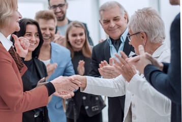 Women are shaking hands at the meeting in office hall