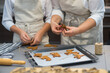© TetianaRUD - the process of making gingerbread. baking holiday cookies at home. cookies of different shapes on a baking sheet