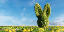 Easter Bunny Made Of Spring Grass And Flowers On Green Meadow.