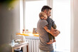 © pikselstock - Dad putting to sleep baby boy in his arms at home