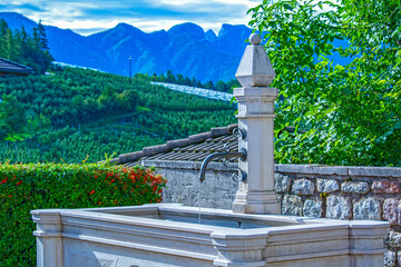 Public water fountain in italian village, Italy