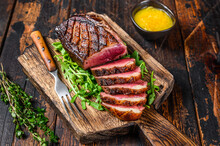 Sliced Grilled Duck Meat Breast Fillet Steak. Dark Wooden Background. Top View
