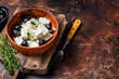 Salad with fresh feta cheese, thyme and olives. Dark background. Top view. Copy space