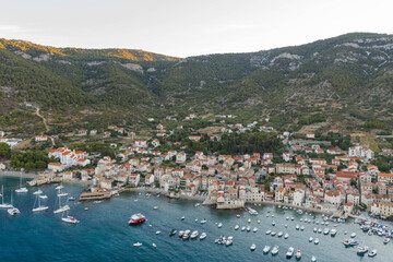 Wall Mural - Aerial drone shot of Adriatic coastline in Komiza town on Vis Island in summer sunrise