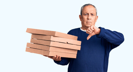 Sticker - Senior handsome man holding pizza boxes with angry face, negative sign showing dislike with thumbs down, rejection concept