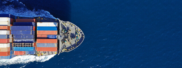 Wall Mural - Aerial drone ultra wide photo of colourful truck size container tanker ship cruising deep blue sea near commercial port of Piraeus, Attica, Greece