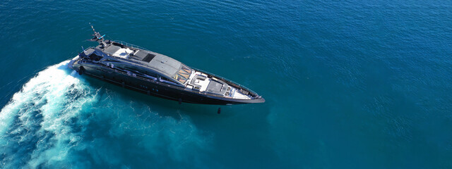 Wall Mural - Aerial drone ultra wide photo of luxury yacht cruising in deep blue sea near Mediterranean Aegean Sea island
