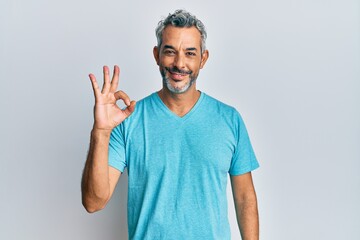 Sticker - Middle age grey-haired man wearing casual clothes smiling positive doing ok sign with hand and fingers. successful expression.