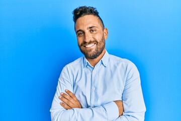 Handsome man with beard wearing casual clothes happy face smiling with crossed arms looking at the camera. positive person.