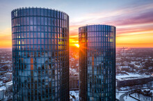 Riga City Panorama At Colorful Sunset In Blue Hour. Modern Skyscrapers Next To Picturesque View Over Riverside In Winter.