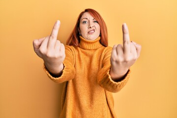 Sticker - Beautiful redhead woman showing middle finger doing bad gesture clueless and confused expression. doubt concept.