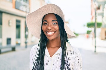 Sticker - Young african american woman on vacation smiling happy walking at street of city