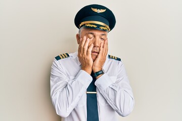 Poster - Handsome middle age mature man wearing airplane pilot uniform tired hands covering face, depression and sadness, upset and irritated for problem