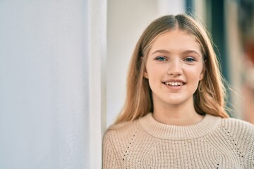 Beautiful caucasian teenager smiling happy standing at the city.